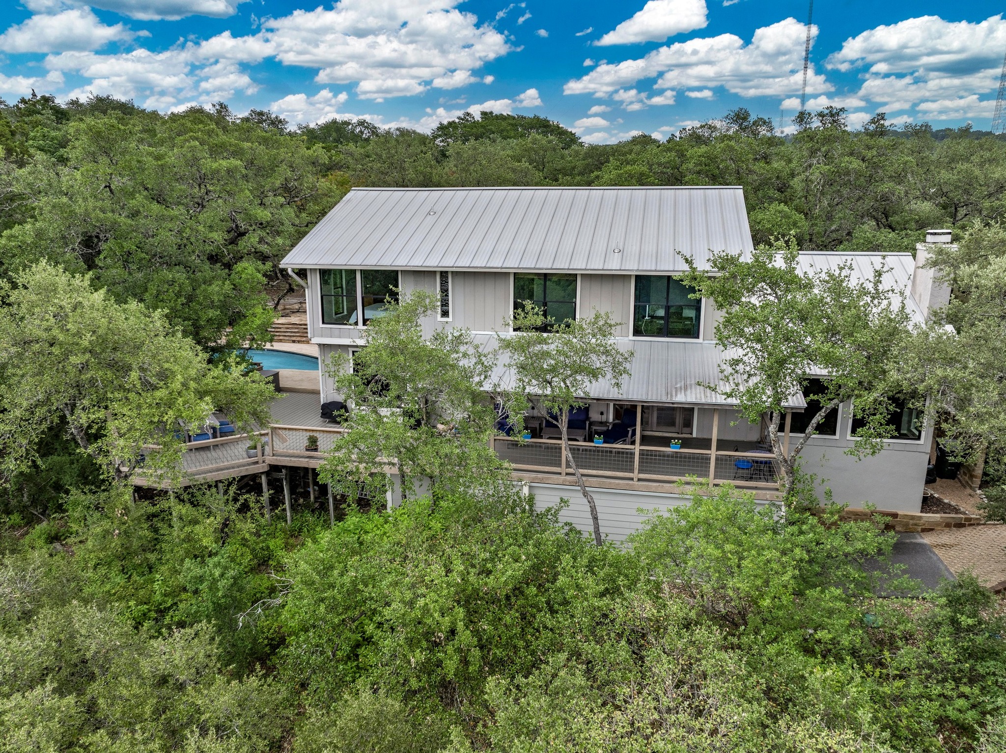 2009 South Oak Canyon Road Austin, TX 78746 - Photo 2 of 37 an aerial view of a house with balcony and garden