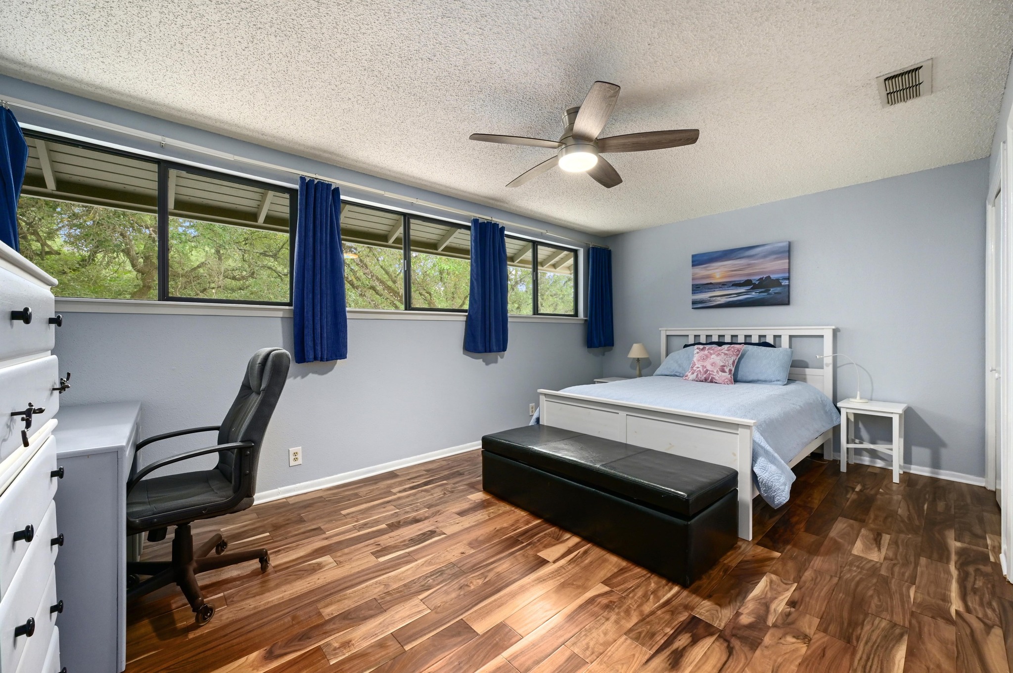 2009 South Oak Canyon Road Austin, TX 78746 - Photo 26 of 37 a bedroom with a bed a large window with table and chair