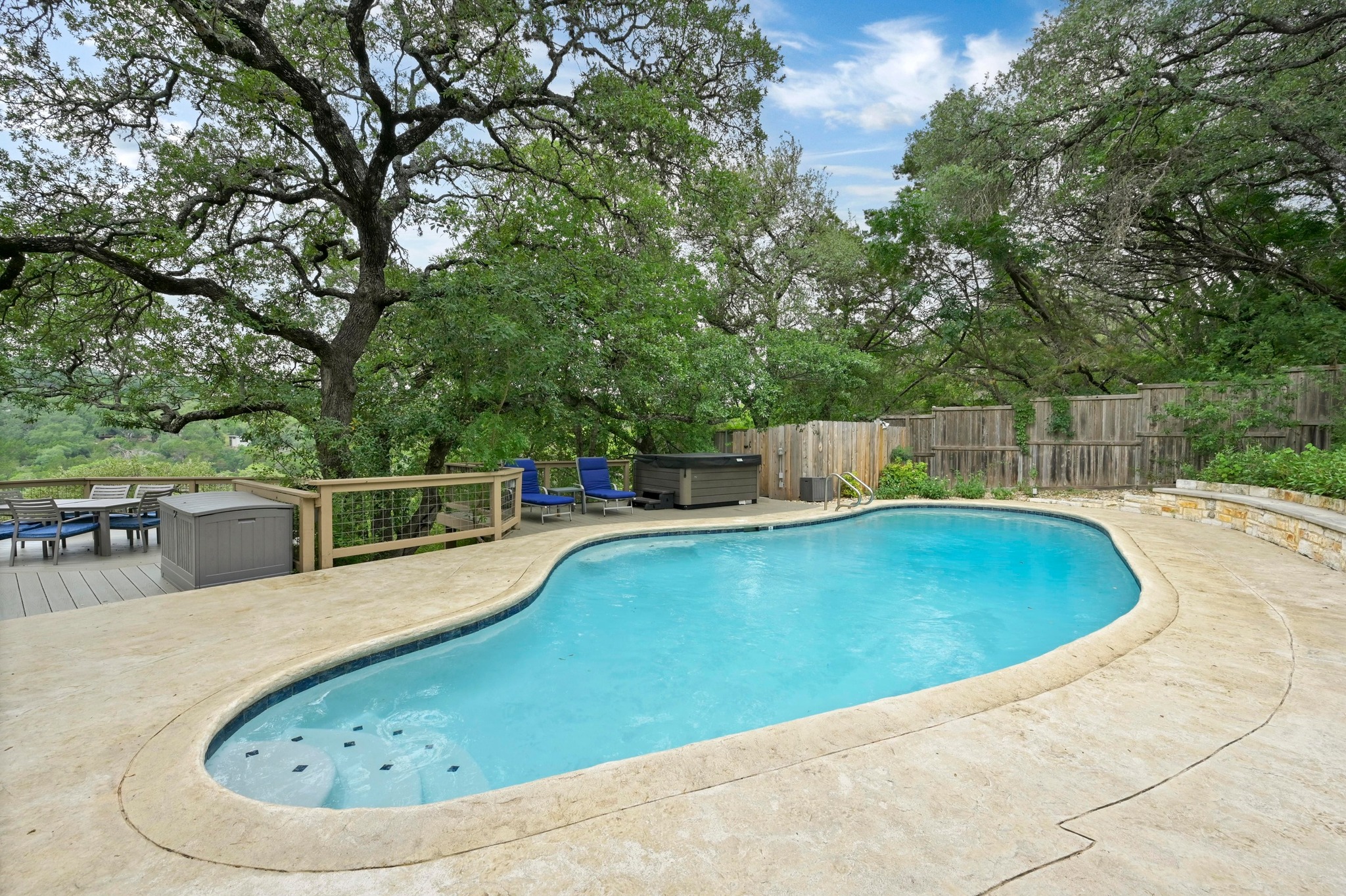 2009 South Oak Canyon Road Austin, TX 78746 - Photo 27 of 37 a view of a swimming pool with a lounge chair