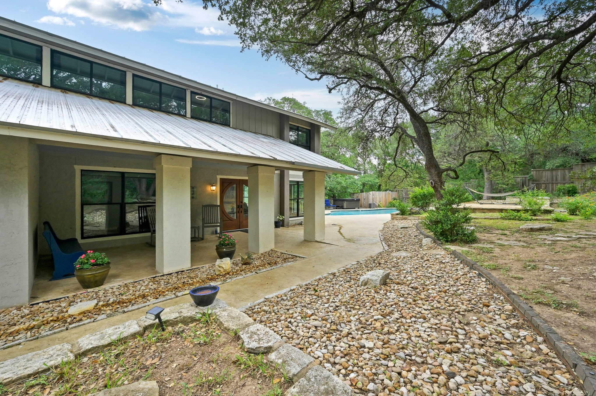 2009 South Oak Canyon Road Austin, TX 78746 - Photo 4 of 37 a view of a house with a patio
