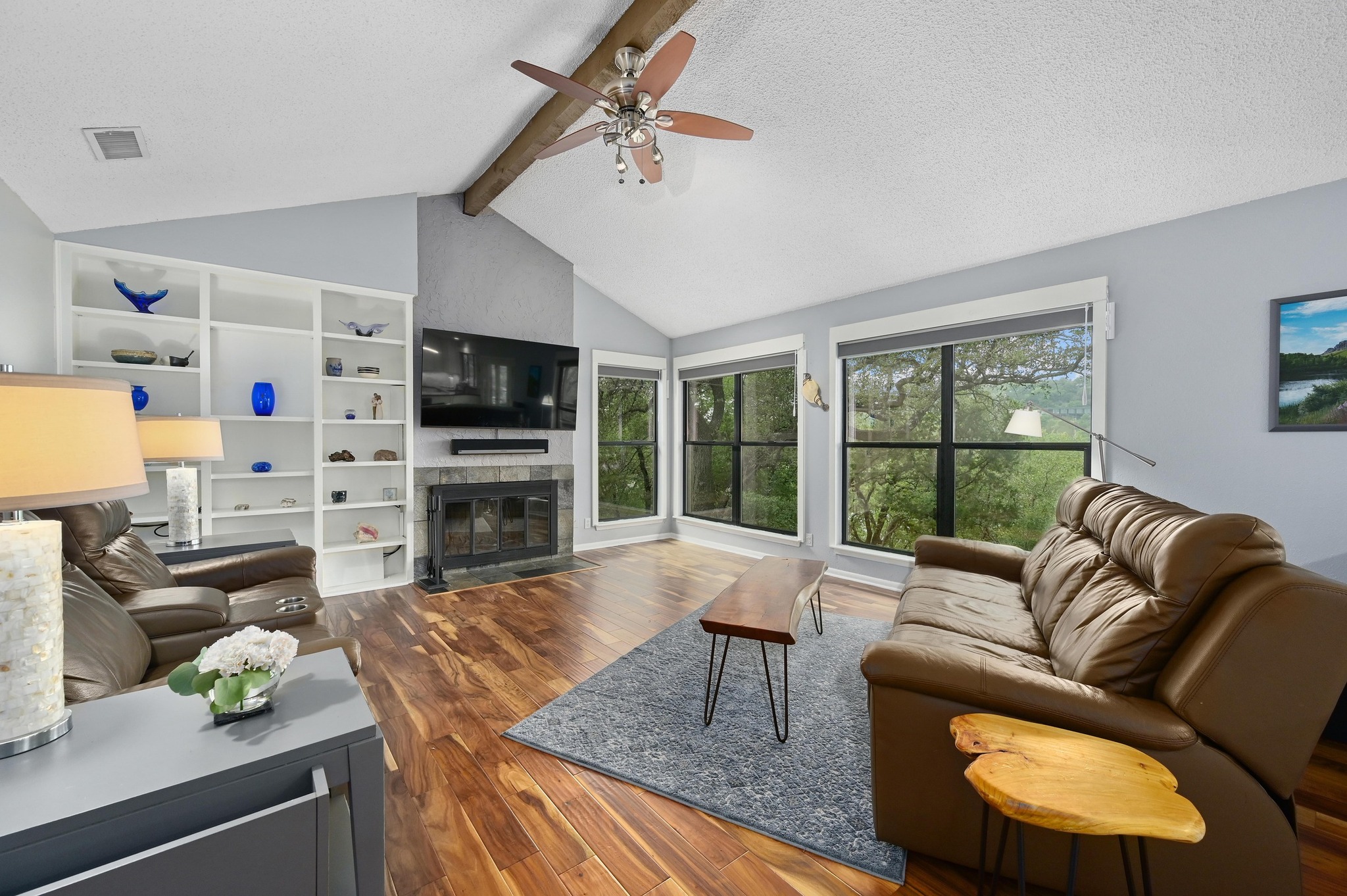 2009 South Oak Canyon Road Austin, TX 78746 - Photo 8 of 37 a living room with furniture a flat screen tv and a fireplace