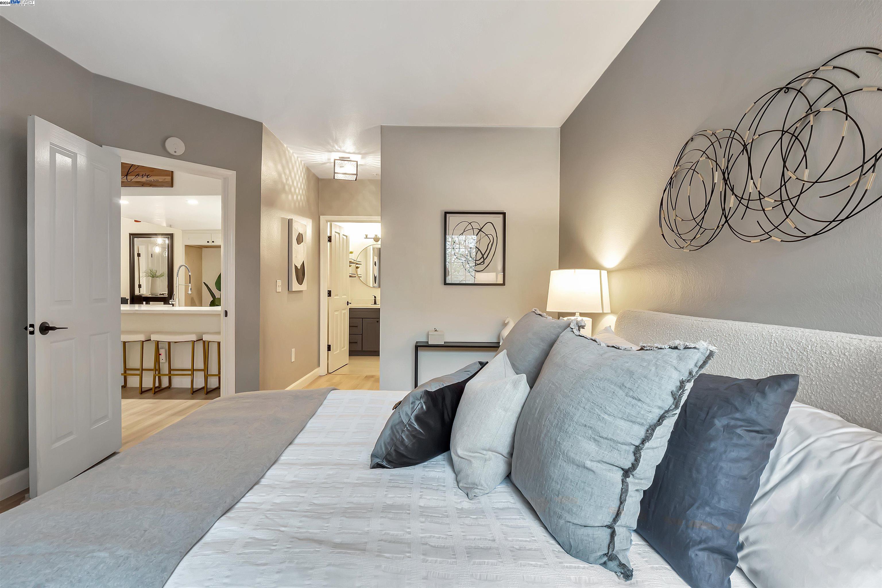 Undisclosed Address San Ramon, CA 94583 - Photo 14 of 40 a bedroom with a large bed and a chandelier