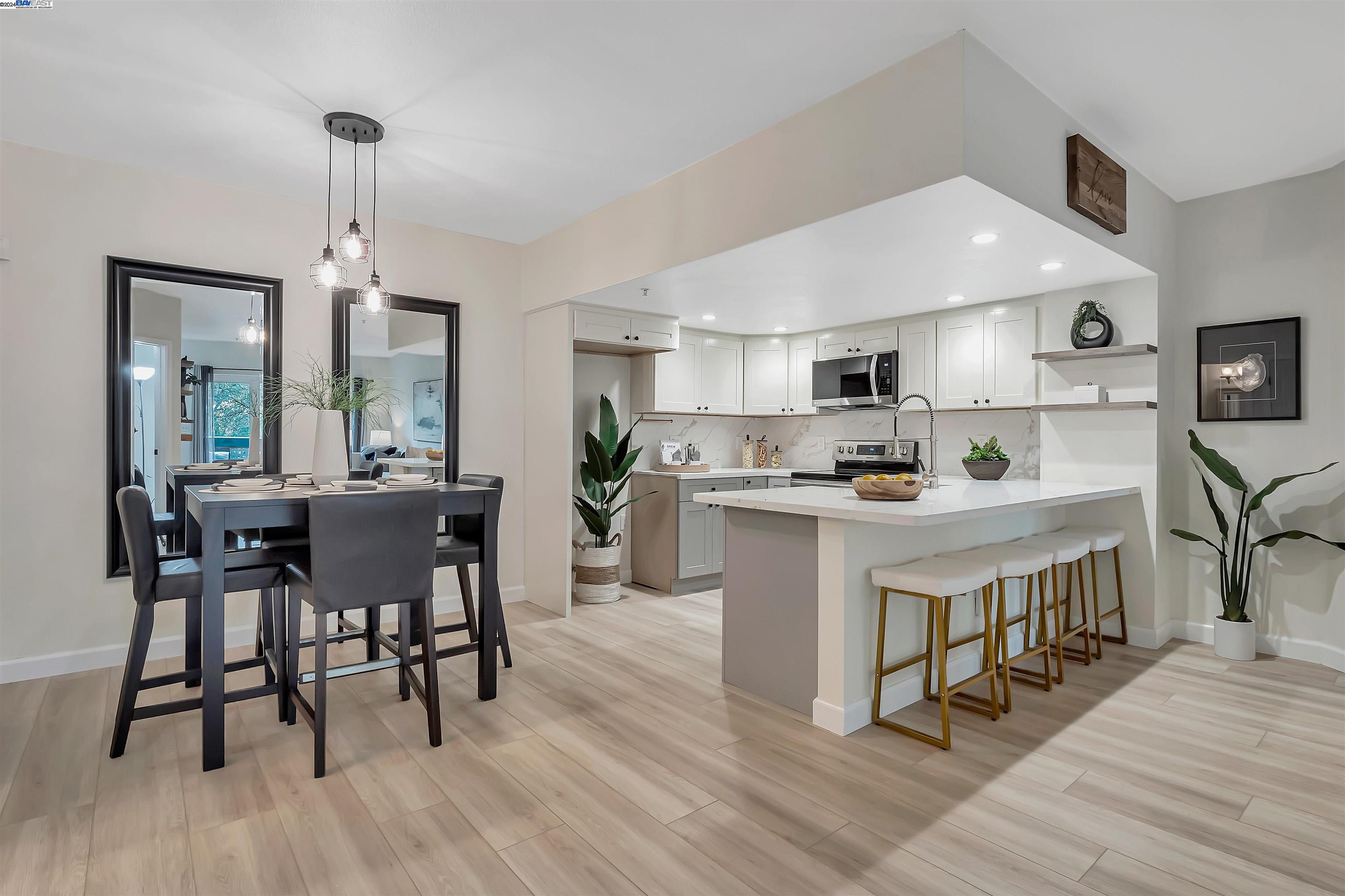 Undisclosed Address San Ramon, CA 94583 - Photo 15 of 40 a kitchen with stainless steel appliances granite countertop a stove a refrigerator a kitchen island a dining table and chairs with wooden floor