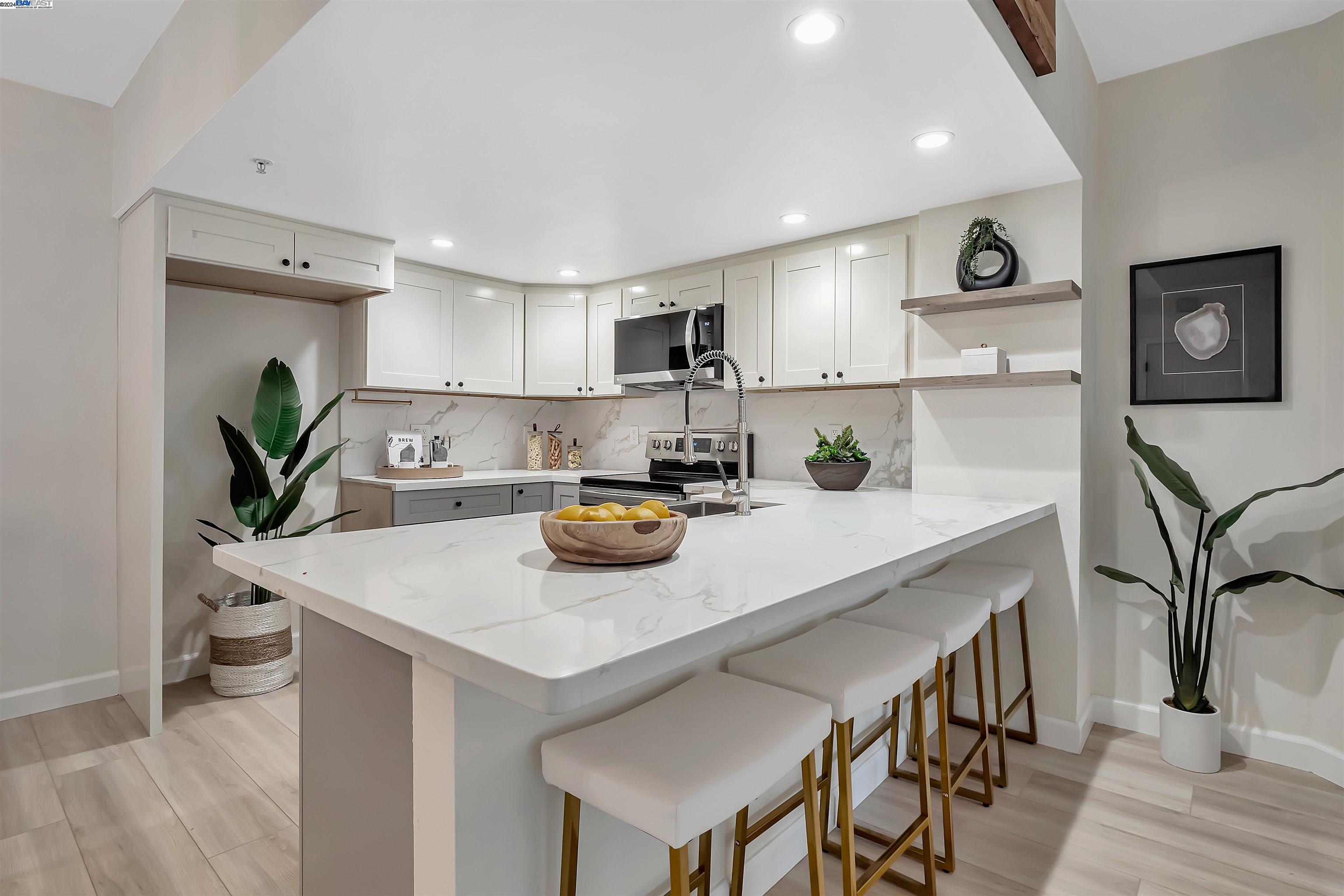 Undisclosed Address San Ramon, CA 94583 - Photo 19 of 40 a kitchen with a sink a stove and chairs