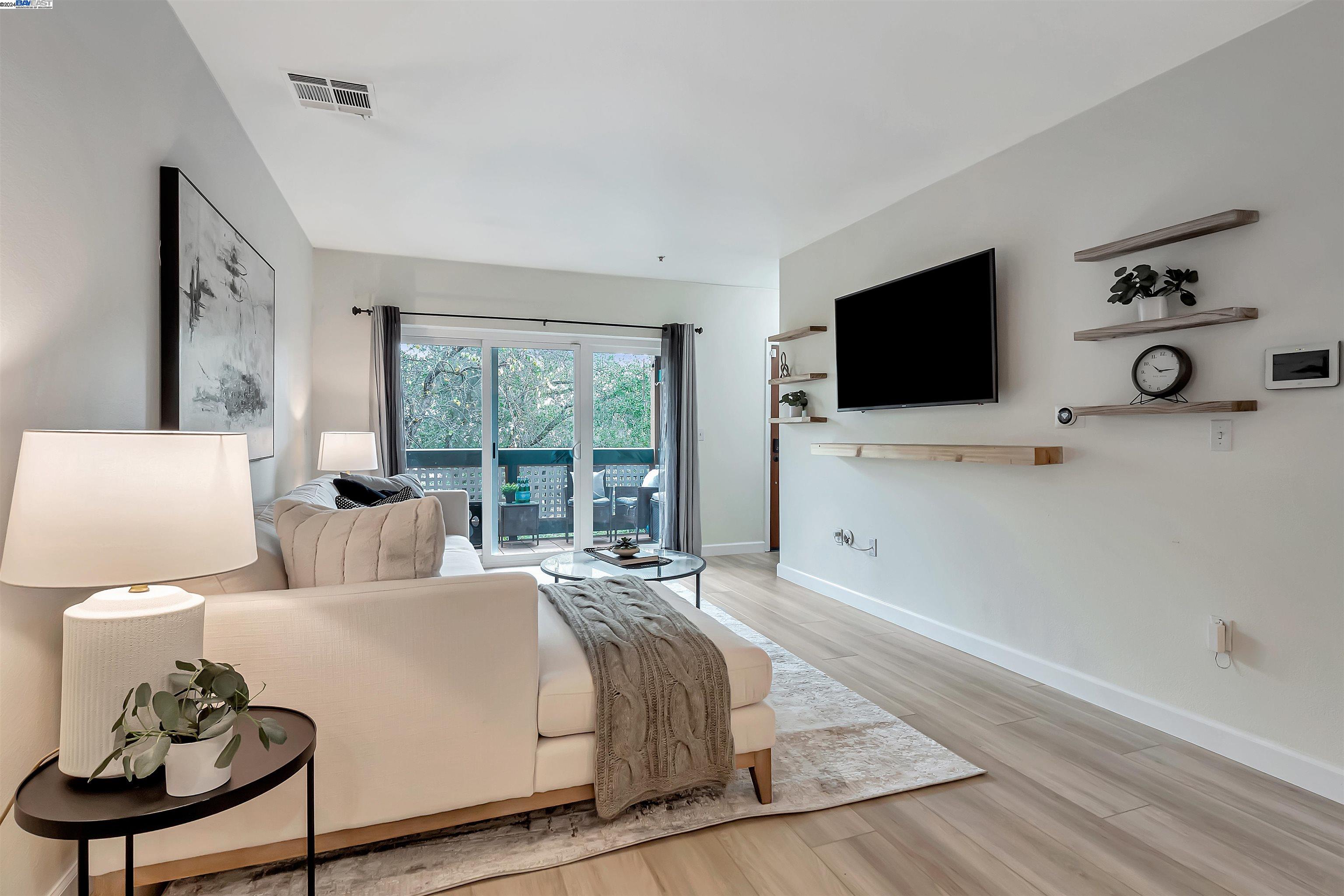 Undisclosed Address San Ramon, CA 94583 - Photo 26 of 40 a living room with furniture a flat screen tv and a large window