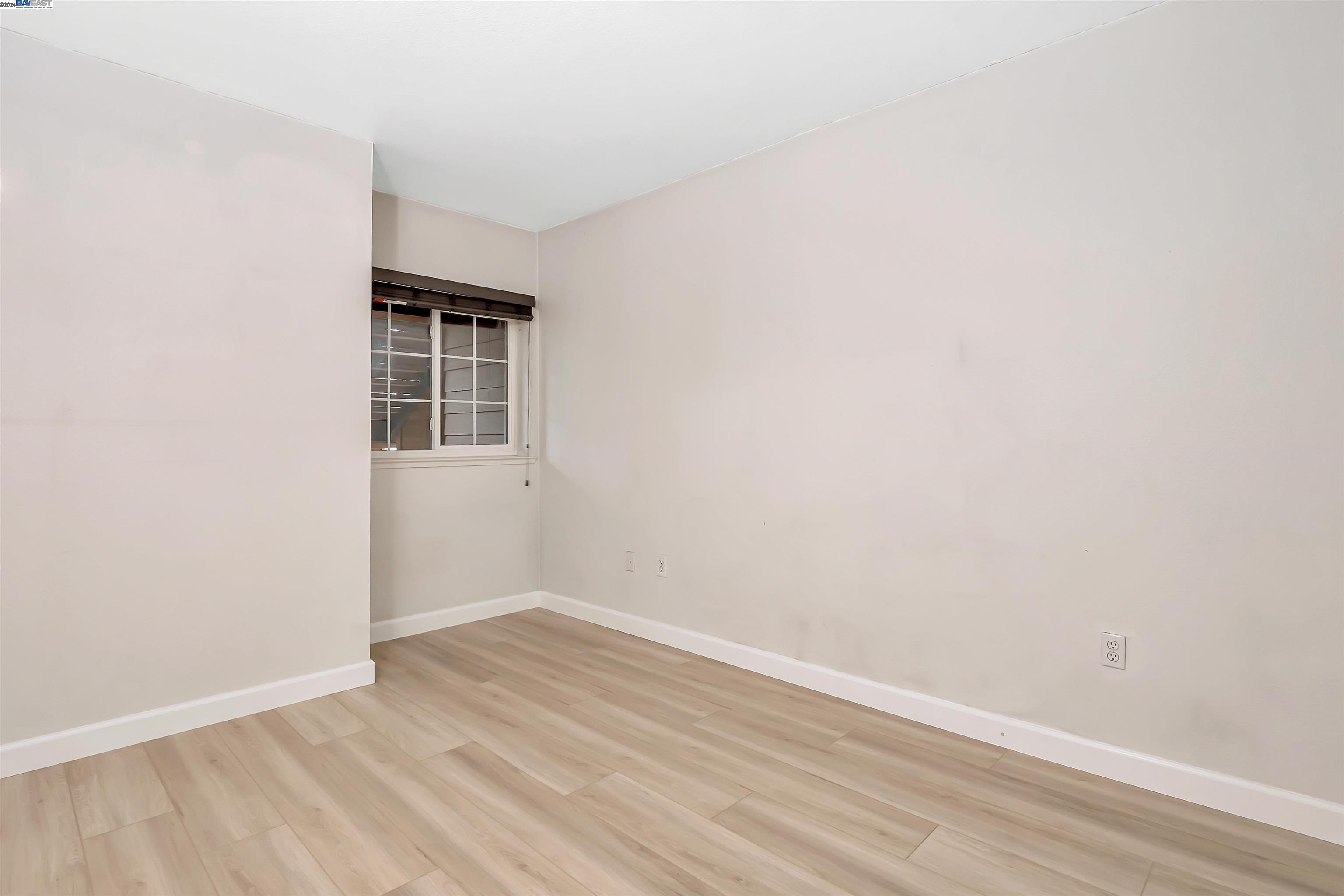 Undisclosed Address San Ramon, CA 94583 - Photo 32 of 40 a view of an empty room with wooden floor and a window