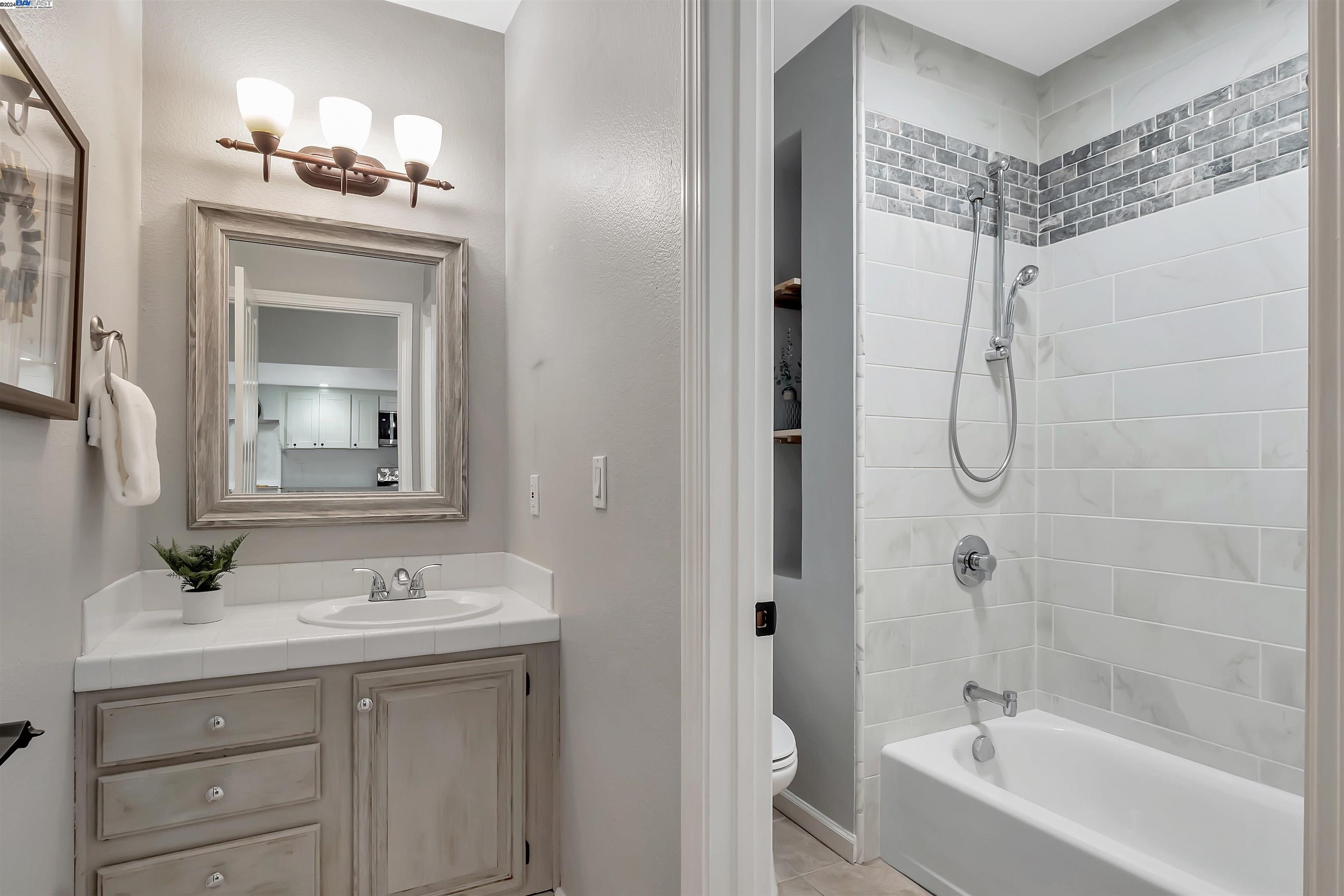 Undisclosed Address San Ramon, CA 94583 - Photo 33 of 40 a bathroom with a sink a toilet a mirror and shower