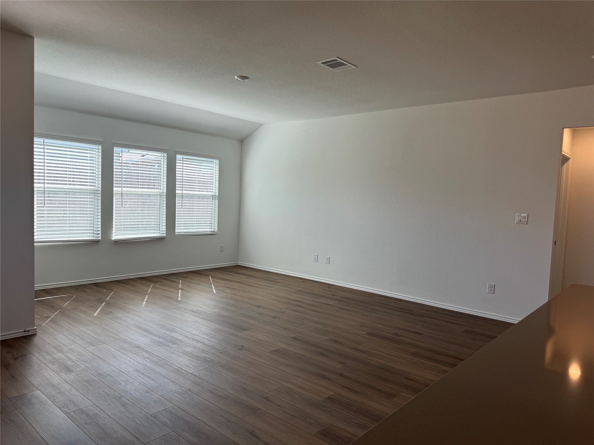 176 Mayacama Loop San Marcos, TX 78666 - Photo 6 of 21 an empty room with wooden floor and windows