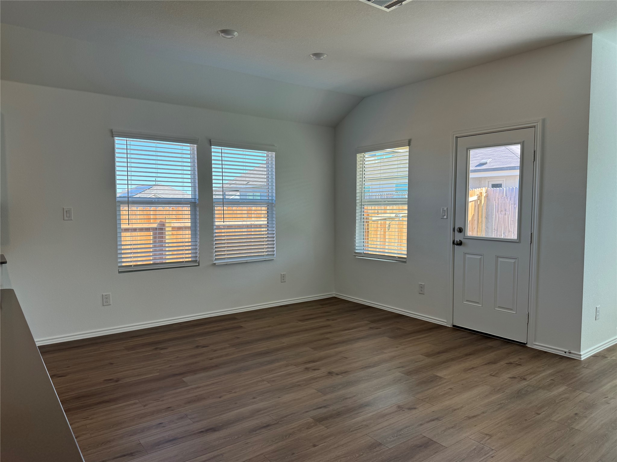 176 Mayacama Loop San Marcos, TX 78666 - Photo 7 of 21 a view of an empty room with wooden floor and a window
