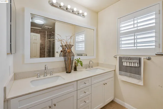 a bathroom with a sink double vanity and a mirror