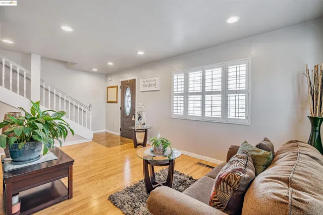 a living room with furniture and a potted plant