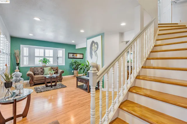 a living room with wooden floor and furniture