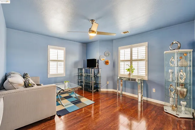 a living room with furniture and wooden floor