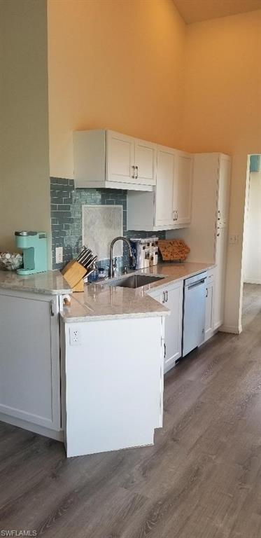 81 Silver Oaks Circle, Unit 7204 Naples, FL 34119 - Photo 12 of 33 a kitchen with a sink a stove cabinets and wooden floor