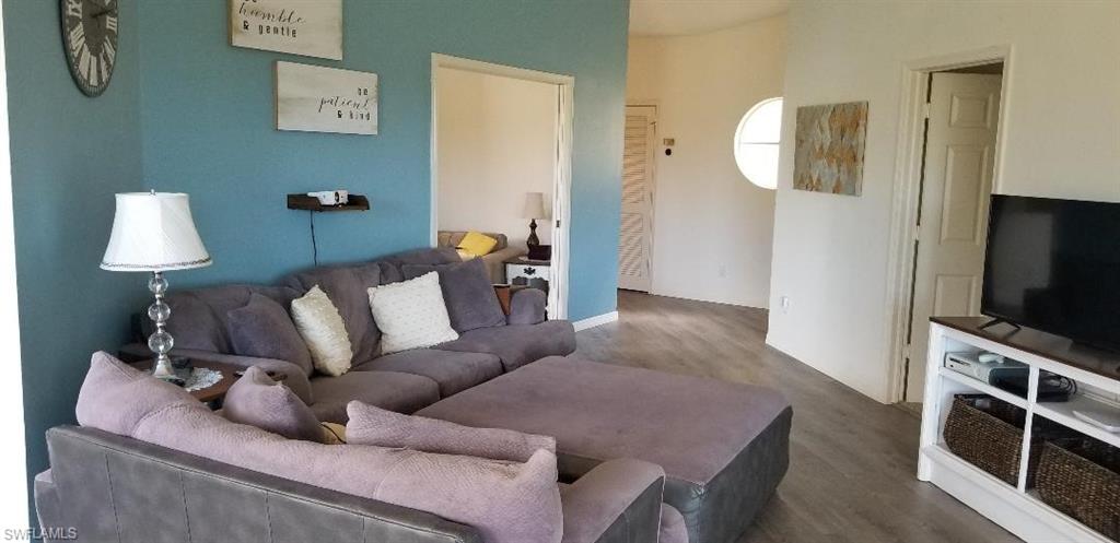 81 Silver Oaks Circle, Unit 7204 Naples, FL 34119 - Photo 13 of 33 a living room with furniture and a flat screen tv