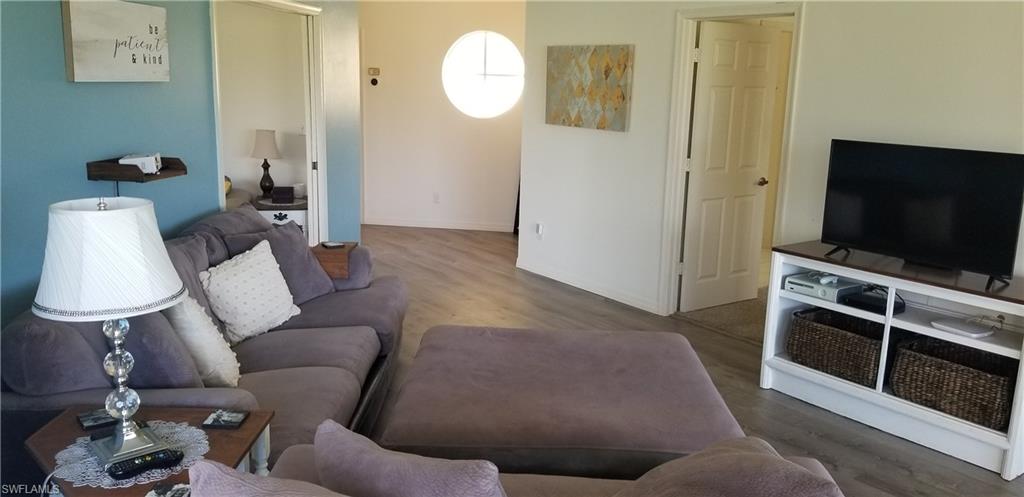 81 Silver Oaks Circle, Unit 7204 Naples, FL 34119 - Photo 14 of 33 a living room with furniture and a flat screen tv