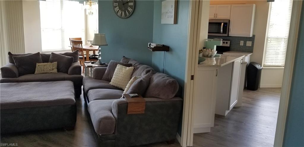 81 Silver Oaks Circle, Unit 7204 Naples, FL 34119 - Photo 15 of 33 a living room with furniture and a window