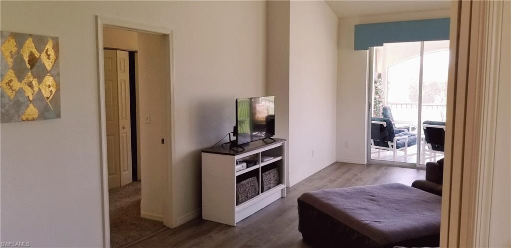 81 Silver Oaks Circle, Unit 7204 Naples, FL 34119 - Photo 16 of 33 a view of a hallway with bathroom and a livingroom