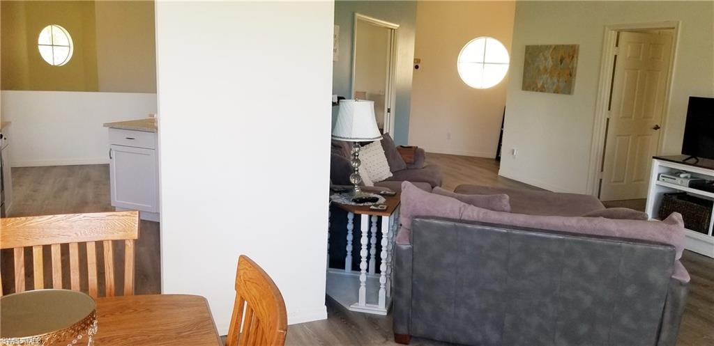 81 Silver Oaks Circle, Unit 7204 Naples, FL 34119 - Photo 17 of 33 a living room with furniture and a mirror