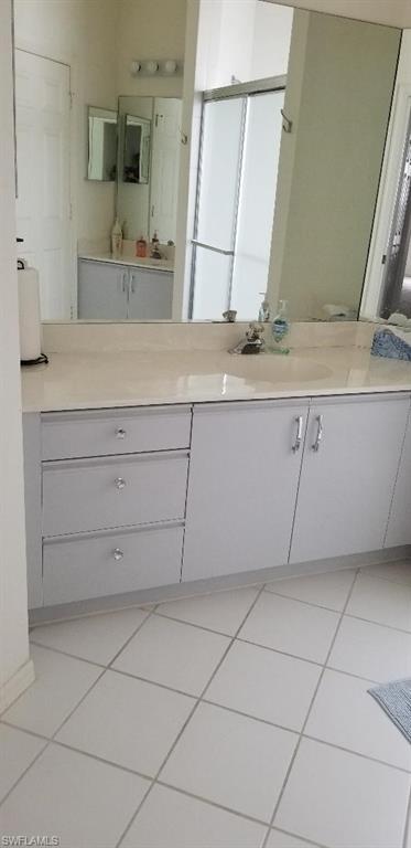 81 Silver Oaks Circle, Unit 7204 Naples, FL 34119 - Photo 20 of 33 a bathroom with a sink and a mirror