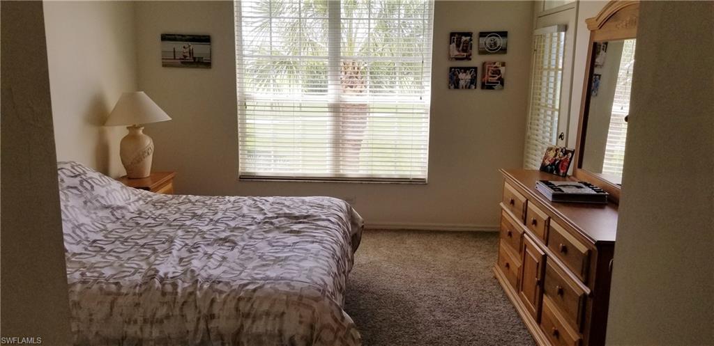 81 Silver Oaks Circle, Unit 7204 Naples, FL 34119 - Photo 23 of 33 a bedroom with a bed and a window