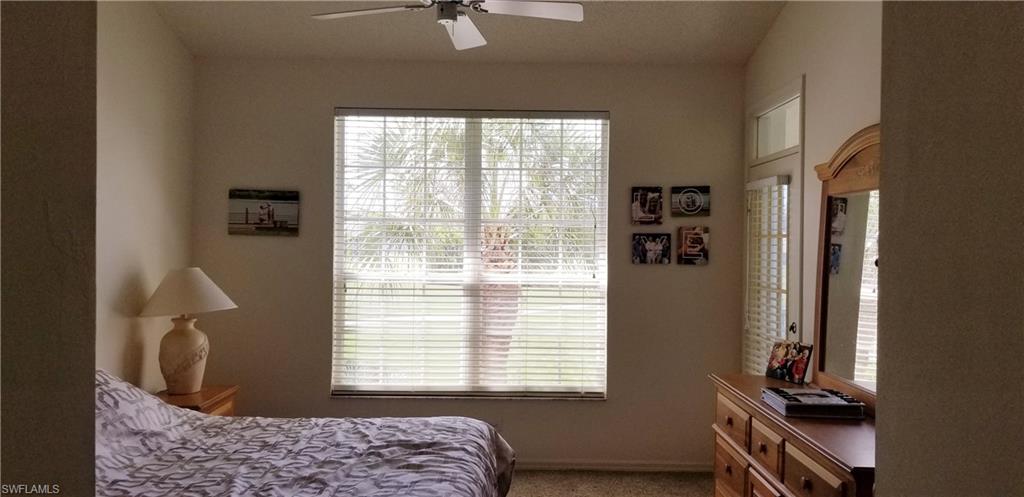 81 Silver Oaks Circle, Unit 7204 Naples, FL 34119 - Photo 24 of 33 a bedroom with a bed and a window