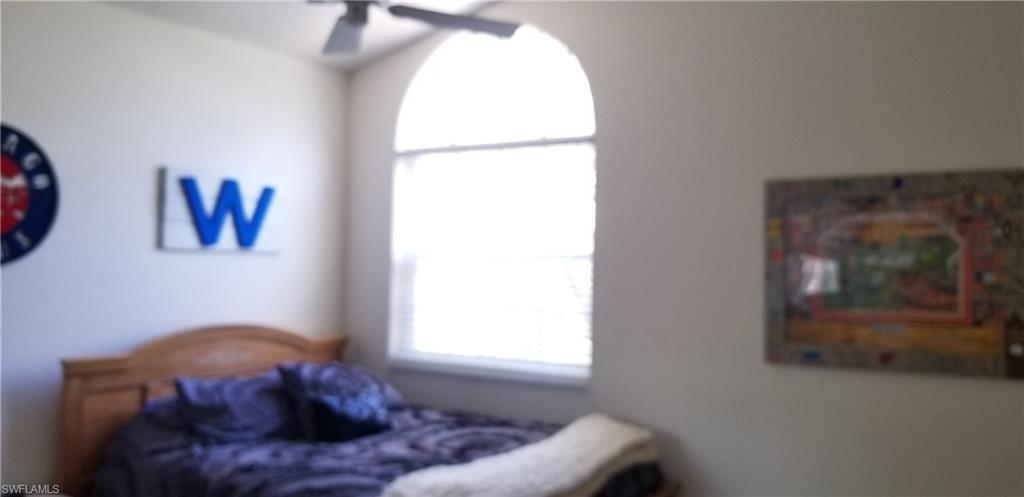 81 Silver Oaks Circle, Unit 7204 Naples, FL 34119 - Photo 25 of 33 a living room with furniture and a window