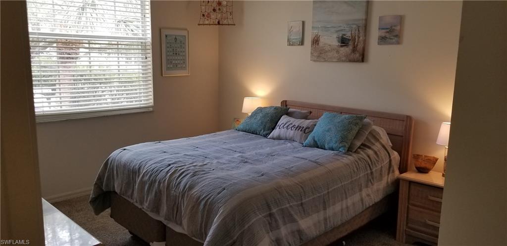 81 Silver Oaks Circle, Unit 7204 Naples, FL 34119 - Photo 26 of 33 a bedroom with a bed and window