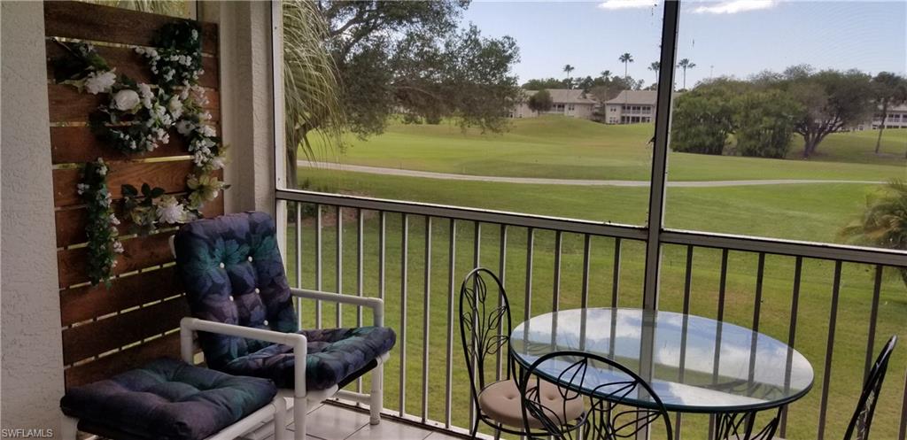 81 Silver Oaks Circle, Unit 7204 Naples, FL 34119 - Photo 28 of 33 a view of balcony with furniture and garden