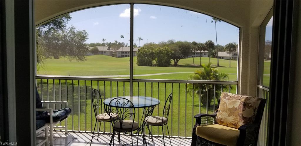 81 Silver Oaks Circle, Unit 7204 Naples, FL 34119 - Photo 32 of 33 a view of a chair and tables in the balcony