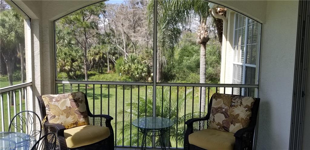 81 Silver Oaks Circle, Unit 7204 Naples, FL 34119 - Photo 33 of 33 a balcony with chairs and a potted plant