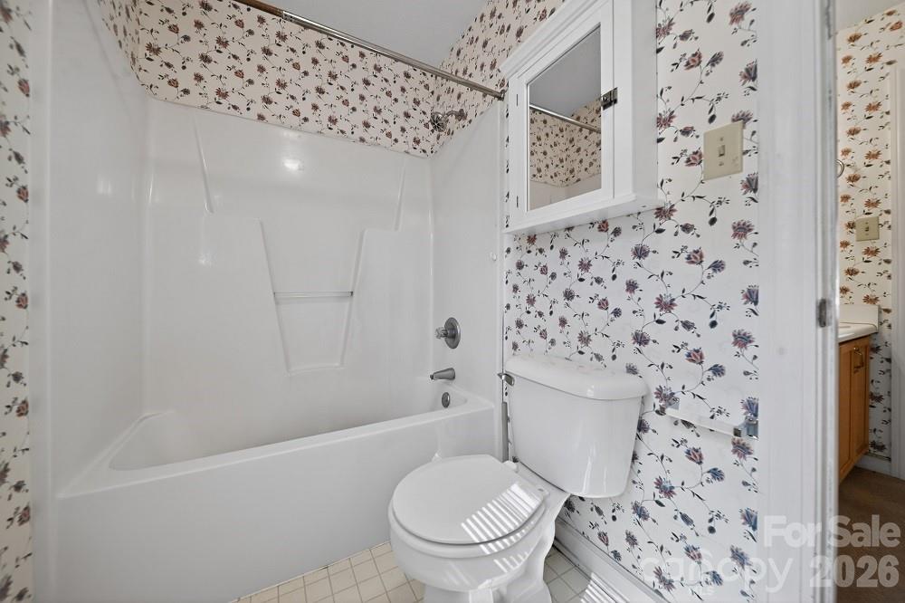 2205 Old Sparta Road Rocky Mount, NC 27804 - Photo 21 of 25 a white toilet sitting next to a shower curtain