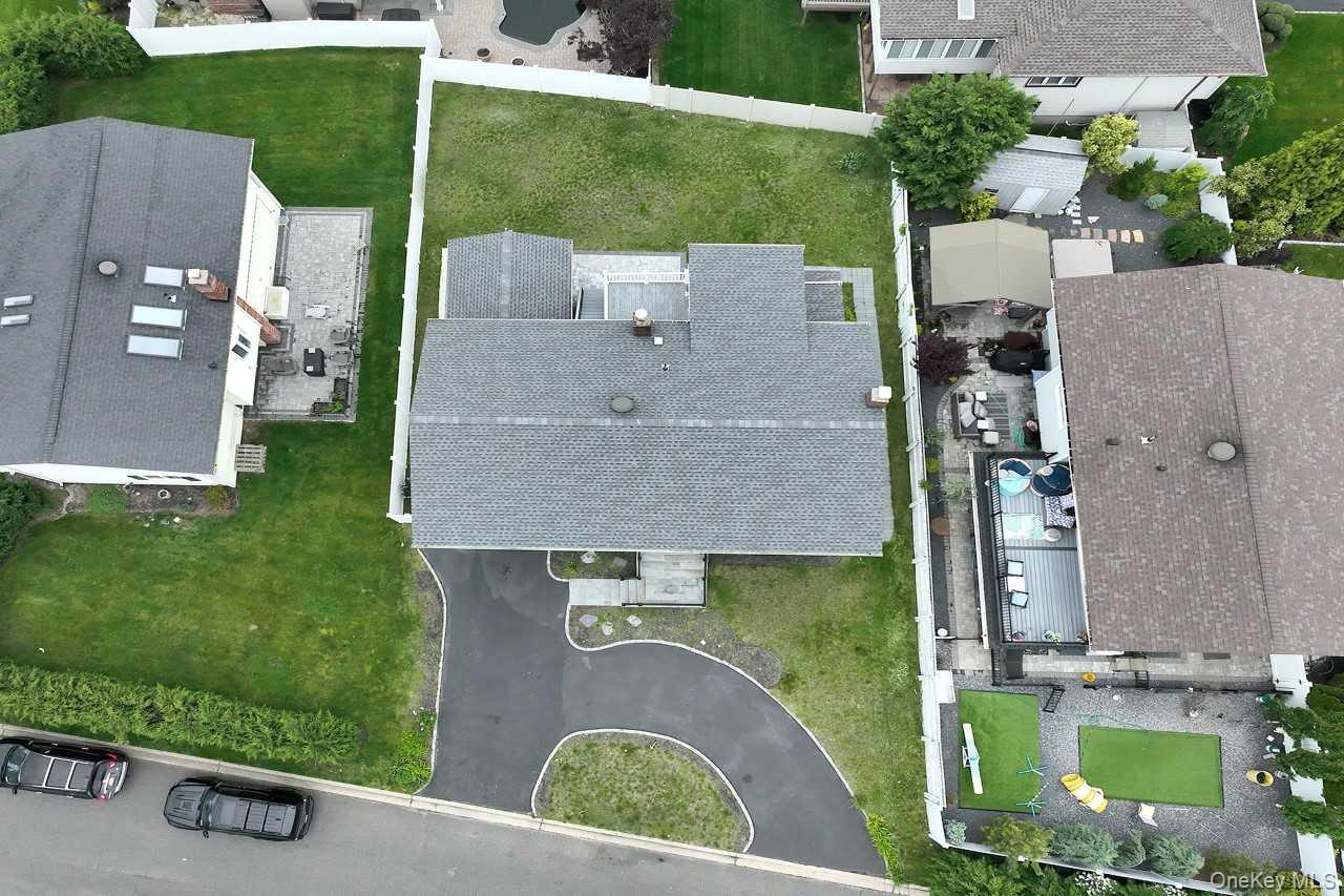 107 Beverly Road Massapequa, NY 11758 - Photo 38 of 41 an aerial view of a house with a yard