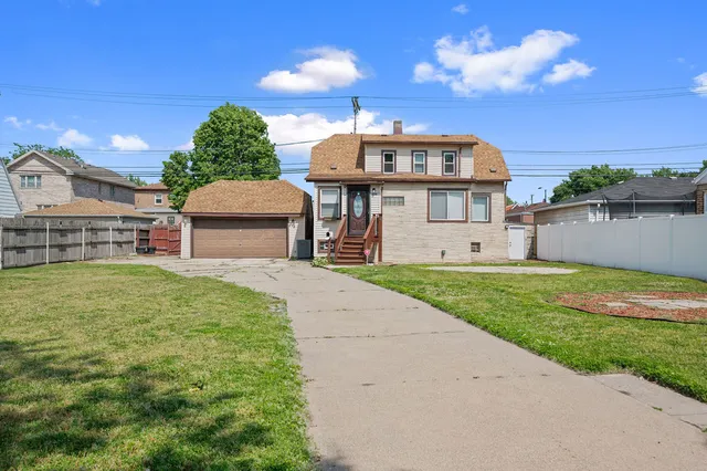 a view of a house with a backyard and a patio