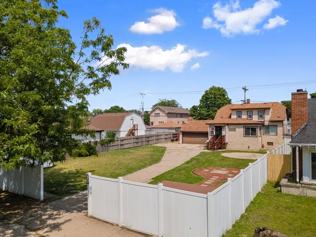 a view of a house with pool and chairs
