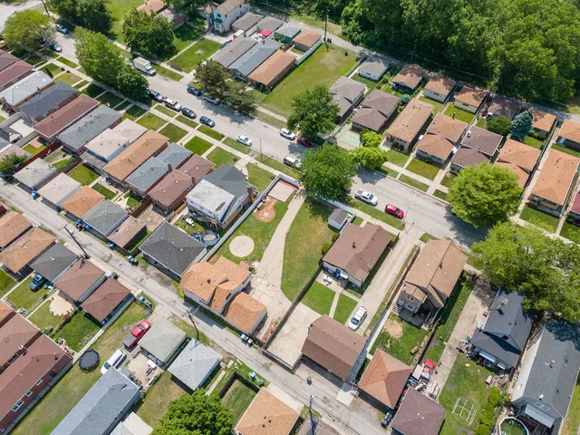 an aerial view of residential house with outdoor space and swimming pool
