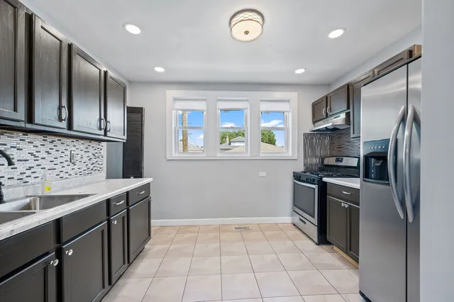 a kitchen with a sink stove and refrigerator