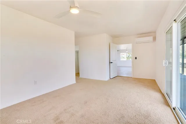 a bathroom with a granite countertop sink a toilet a mirror and bathtub