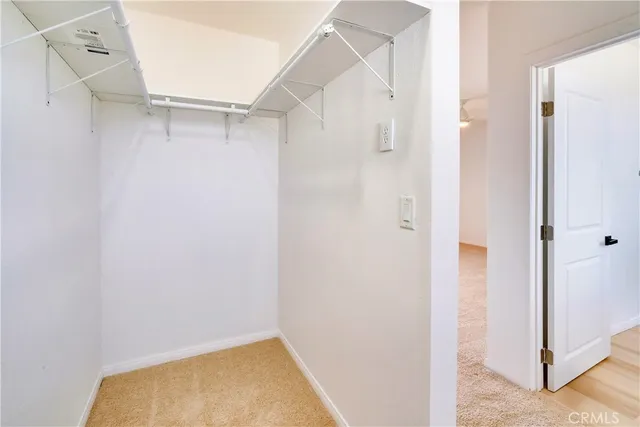 an empty room with a ceiling fan and a window
