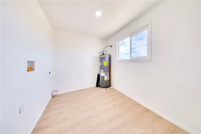 a bathroom with a toilet a sink a mirror and a window