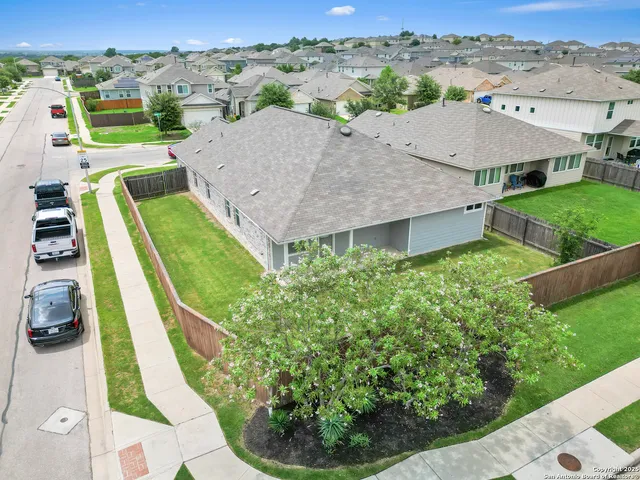 an aerial view of a house with a garden and mountain view