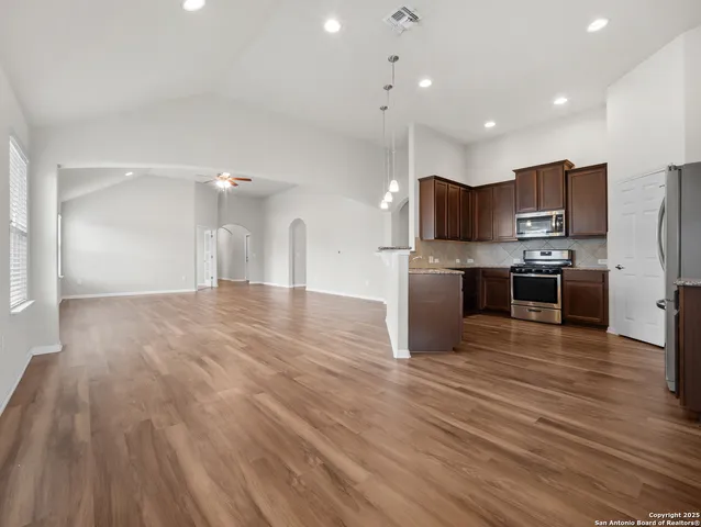 a kitchen with stainless steel appliances a refrigerator and a microwave