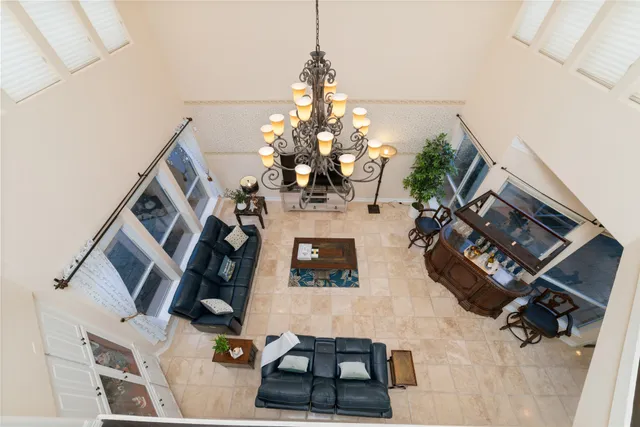a living room with furniture and a chandelier