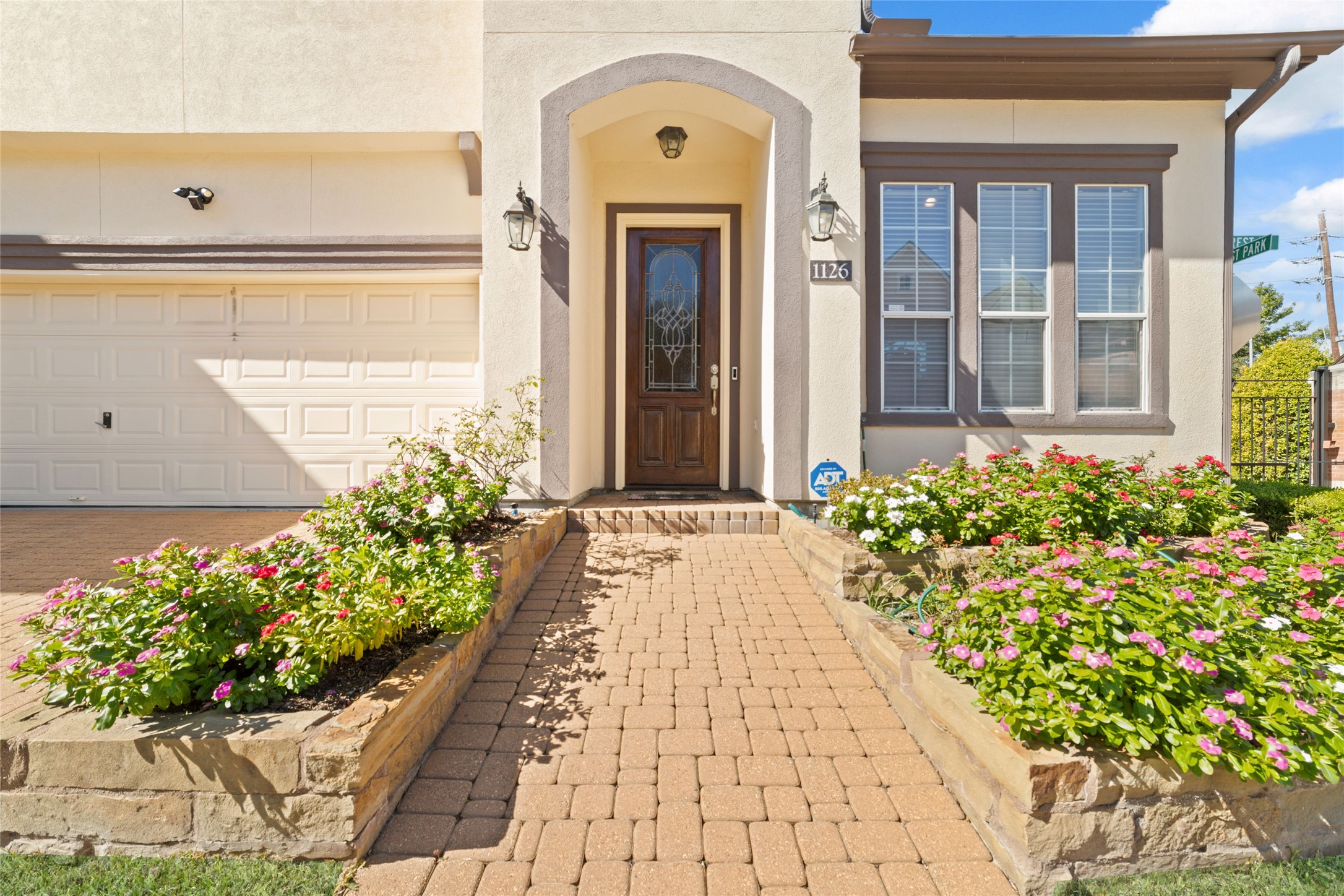 1126 Gardencrest Lane Houston, TX 77077 - Photo 2 of 31 a front view of a house with a lot of flower and flowers