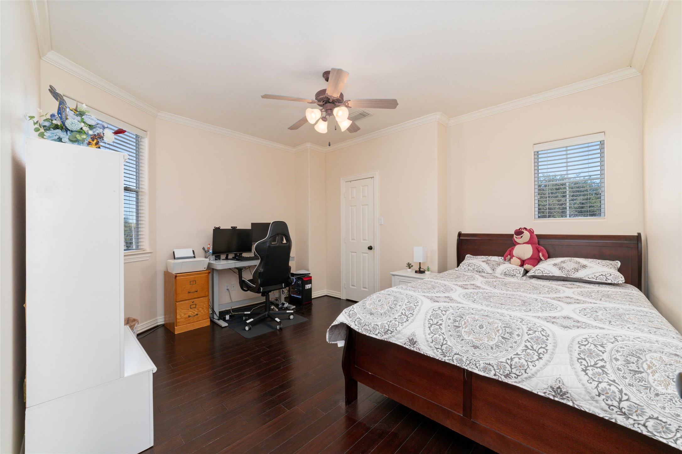 1126 Gardencrest Lane Houston, TX 77077 - Photo 25 of 31 a bedroom with a bed and a chandelier