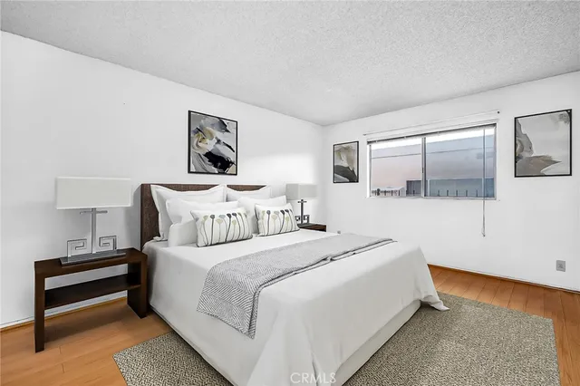 a bedroom with a bed and a lamp with window