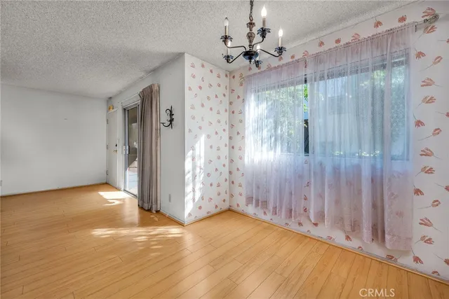 a view of a room with wooden floor and window