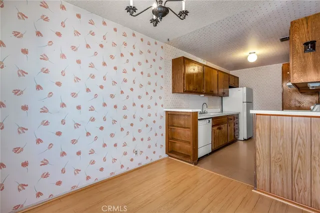 a kitchen with granite countertop a sink and a stove top oven