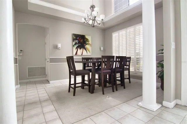 a view of a dining room with furniture and window
