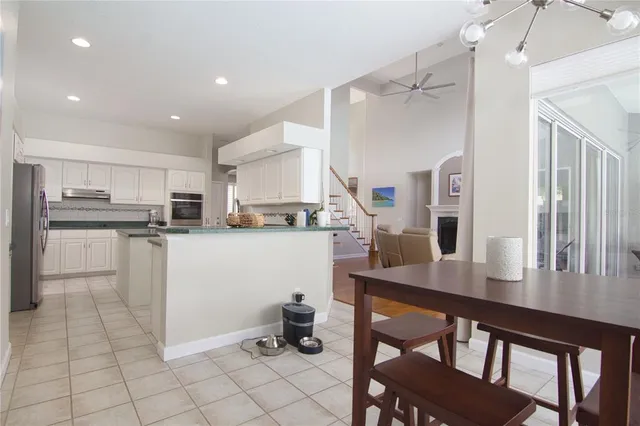 a kitchen with cabinets and chairs